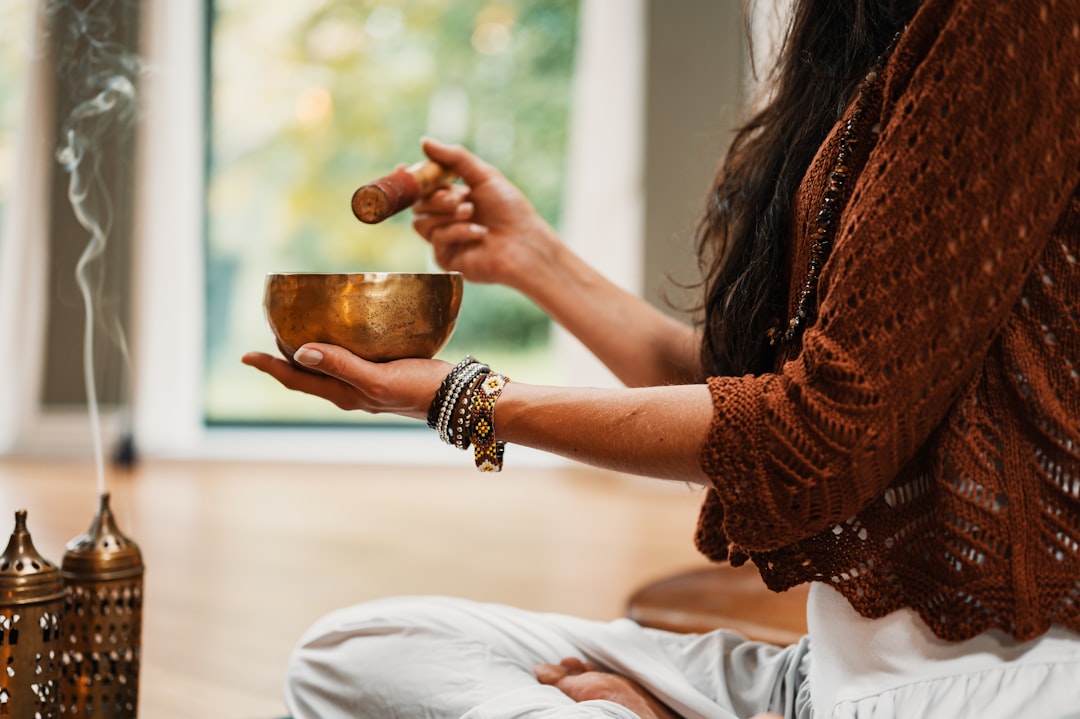 woman-in-brown-knit-sweater-holding-brown-ceramic-cup-vsi-74zrzao